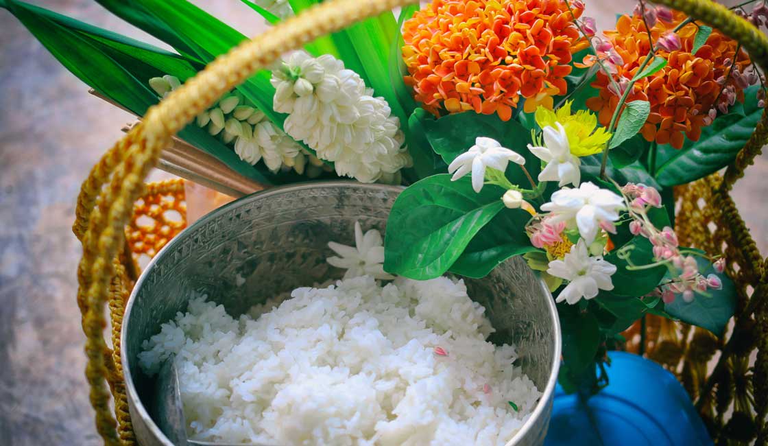 A basket with rice and flowers as an offering to a monk